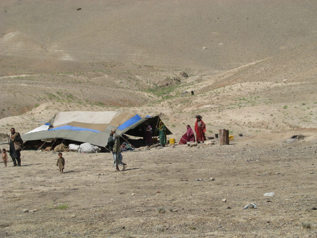 Afghan family living in tents in a remote, dry, mountainous region of Afghanistan