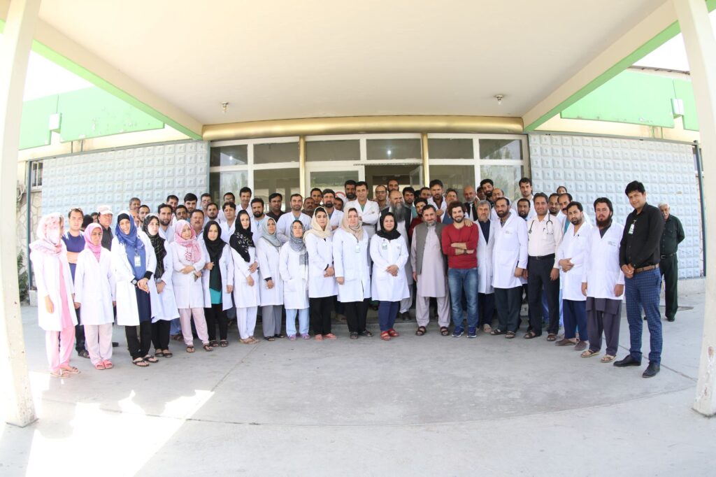 Full staff of Be Team International's Cure Hospital gathered at the hospital entrance in Kabul, Afghanistan