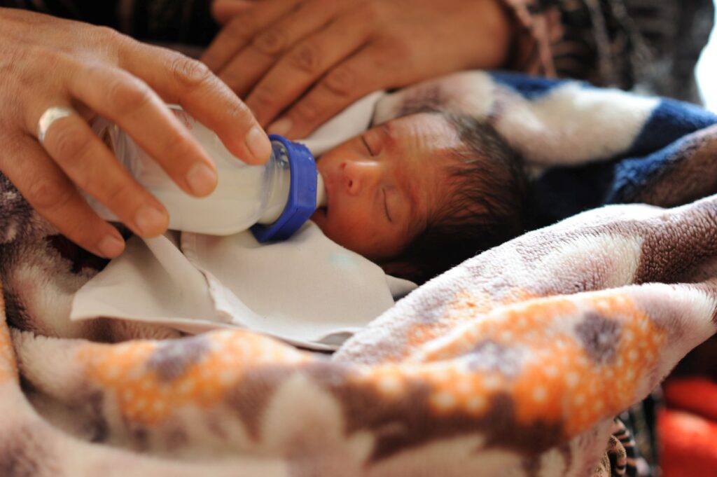 Nurse feeding a newborn baby at Be Team International's Cure Hospital in Kabul, Afghanistan