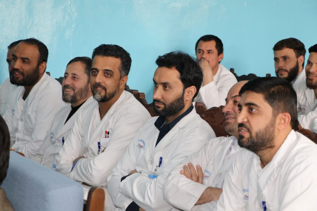 Be Team International Cure Hospital medical professionals in Kabul, Afghanistan listening attentively at a hospital gathering