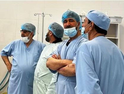 Four Be Team International Cure Hospital surgical team members sharing a relaxed moment in the operating theater in Kabul, Afghanistan