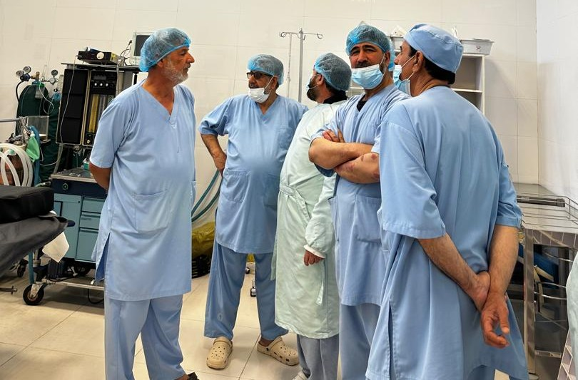 Five Be Team International Cure Hospital surgical team members sharing a relaxed moment in the operating theater in Kabul, Afghanistan