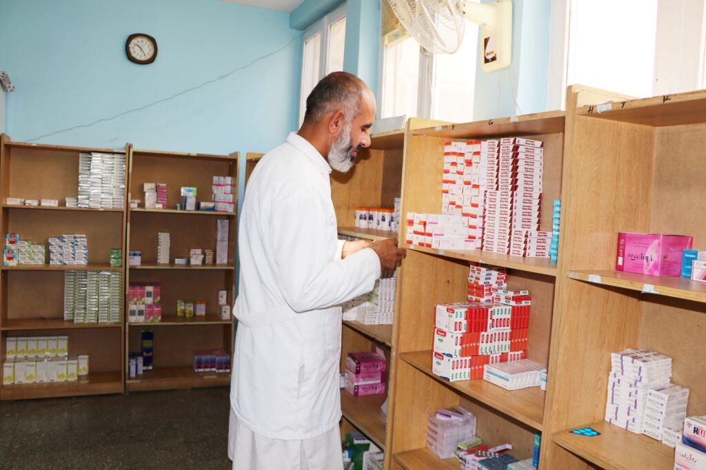 Be Team International Cure Hospital staff member reviewing medical supplies in a supply room in Kabul, Afghanistan
