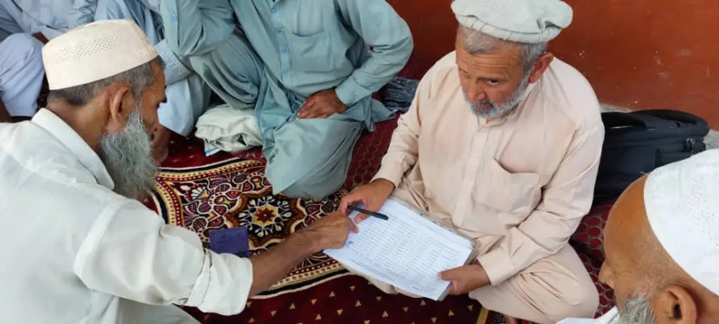 Be Team International team member conducting patient intake during mobile medical care outreach in Afghanistan